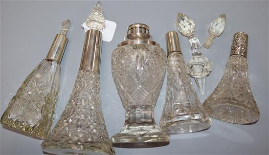 Five assorted early 20th century silver mounted cut glass scent bottles, three of conical form, largest 24.3cm.